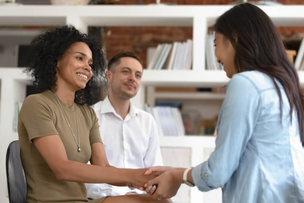 Woman talking to a friend and holding hands