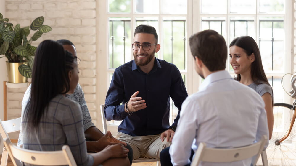 Group of individuals discussing something while in a group session