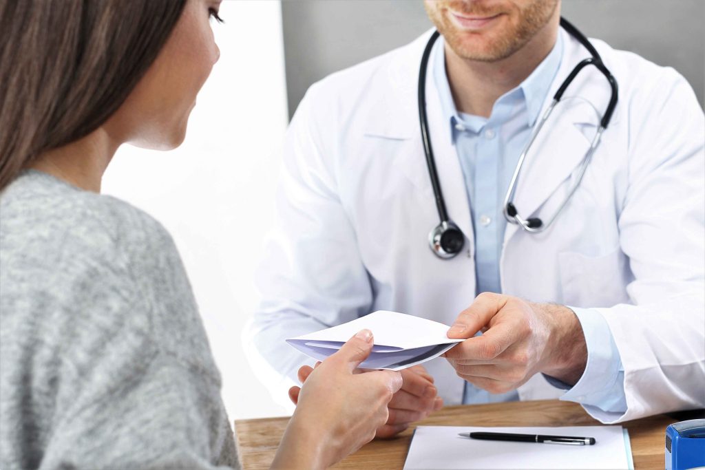 A doctor giving prescription to his patient