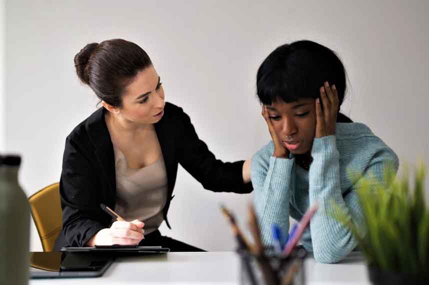 A therapist talking to a stressed girl