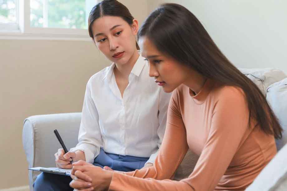 A female therapist talking to her female patient