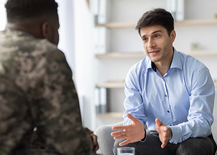 Therapist talking to his male patient