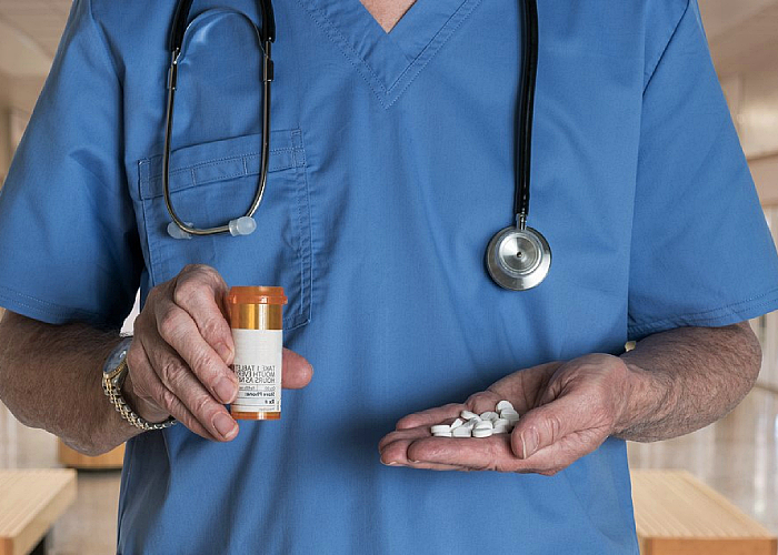 therapist holding prescription pills