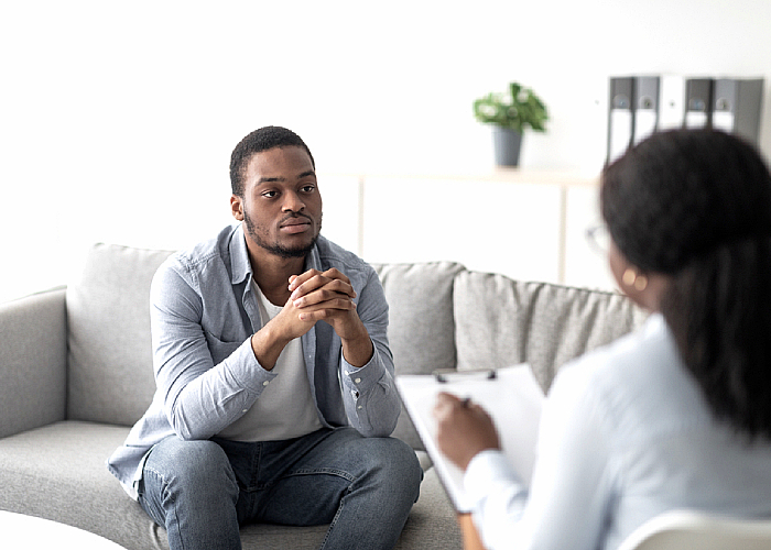 A guy talking to her therapist about his mental issues