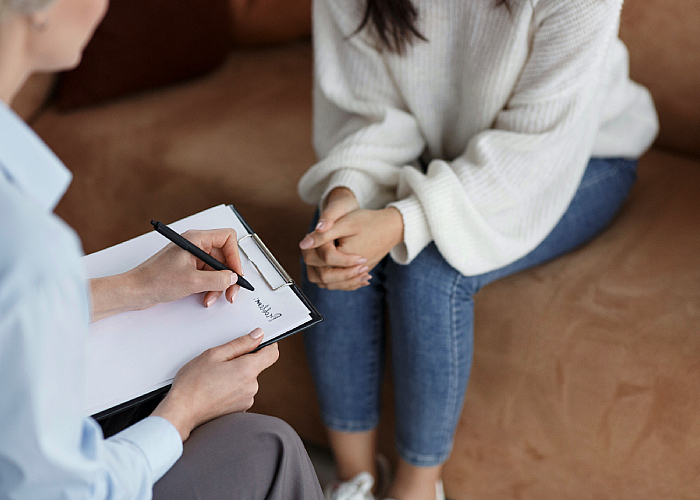 Therapist writing down issues from patients