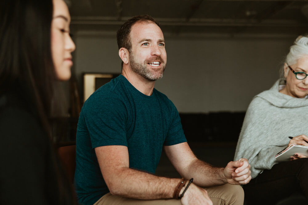 A guy talking to her colleagues