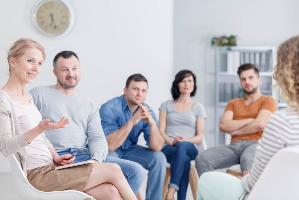 Group of patients listening to their therapist