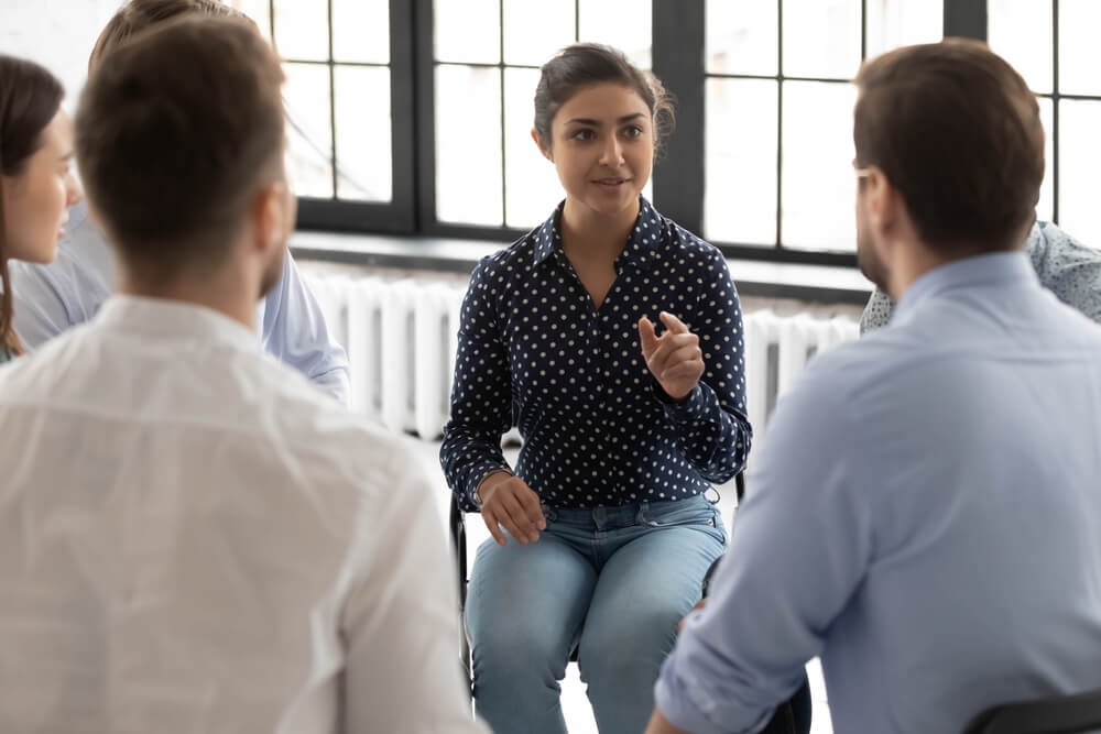 A woman explaining the issues in a group session