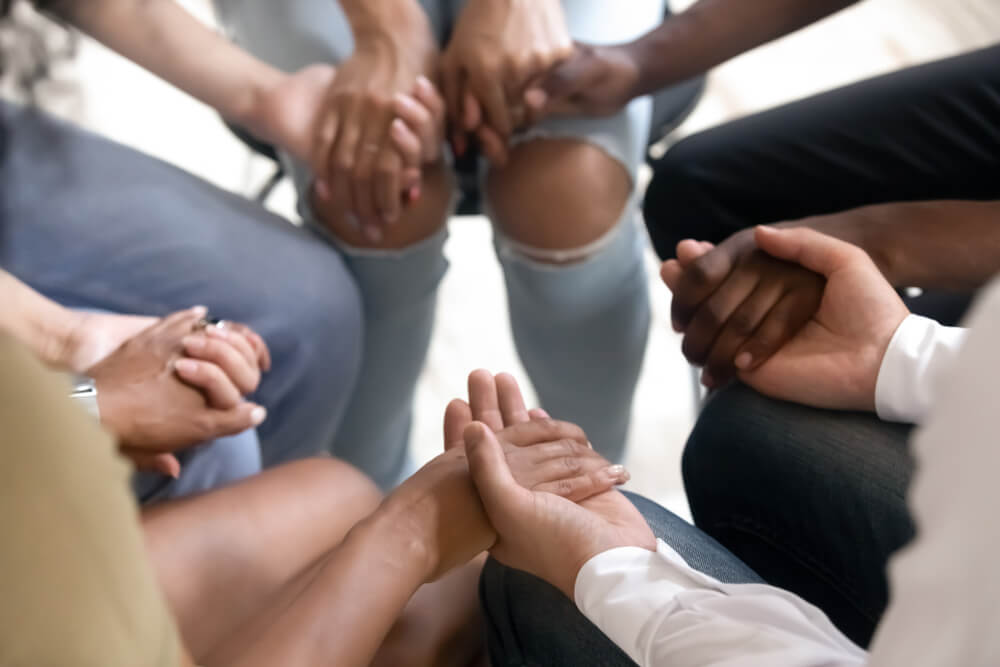 Group on individuals holding hands together