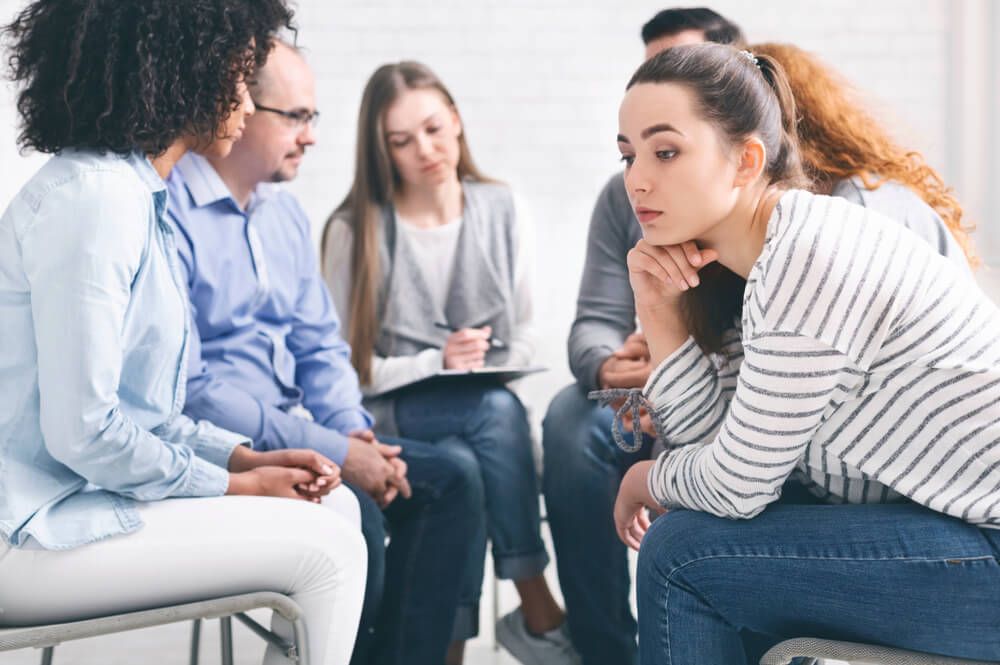 A young woman listening while in a group session