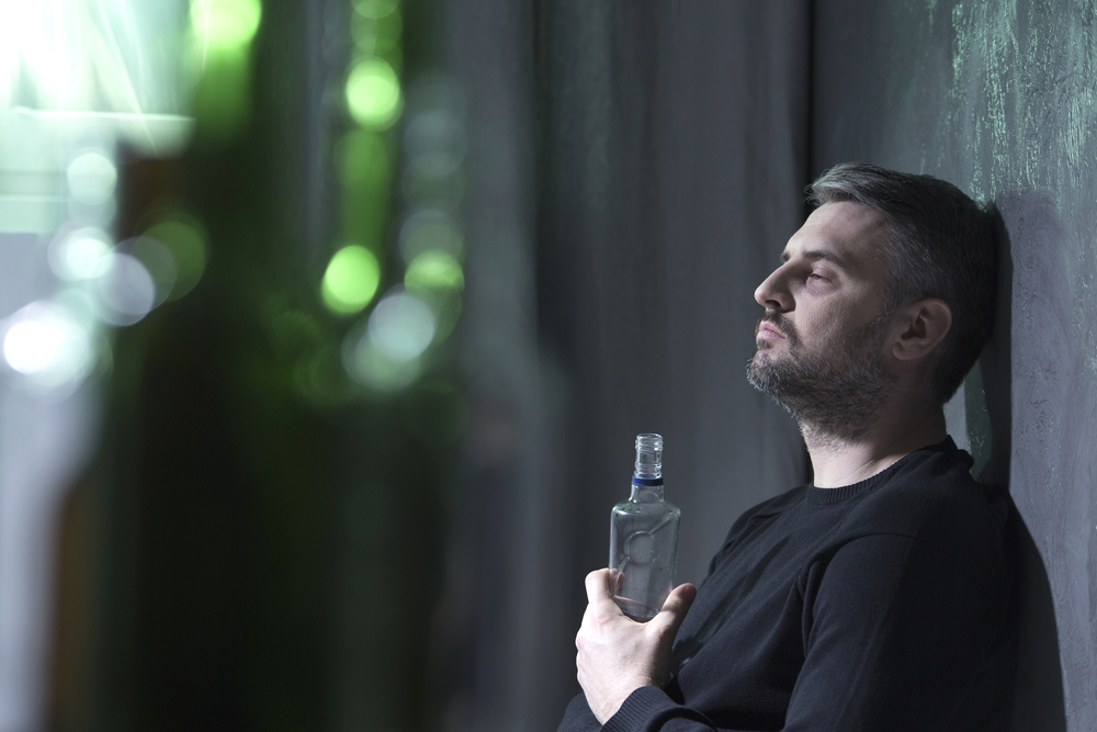 Man holding a bottle of alcohol