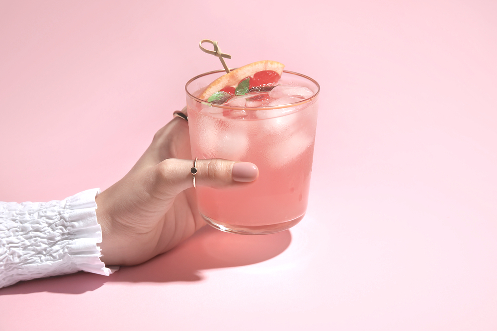 A glass of pink whitney vodka drink