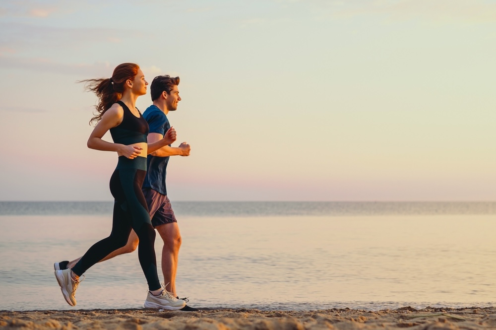 A couple jogging in the beach