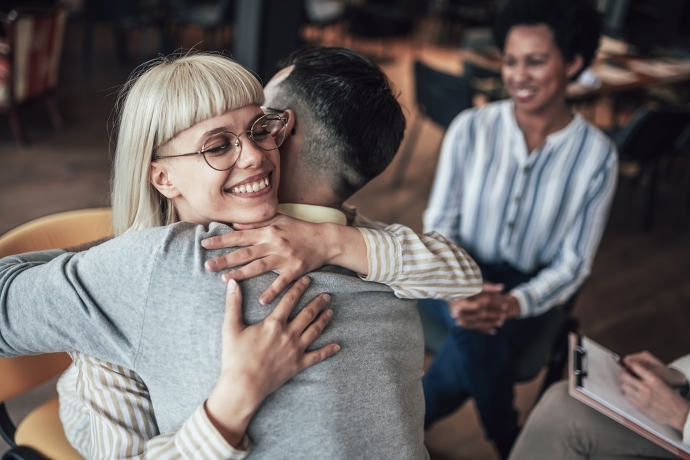 Woman hugging a man as a happy gesture