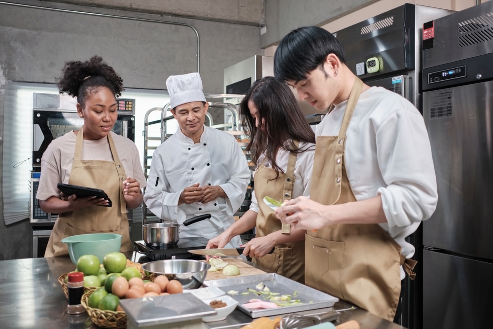 A group of sober people doing cooking activities with a chef