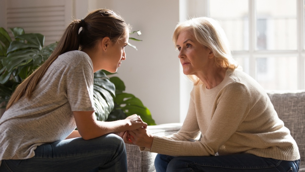 Woman in recovery leaning on her mother for support in addiction recovery