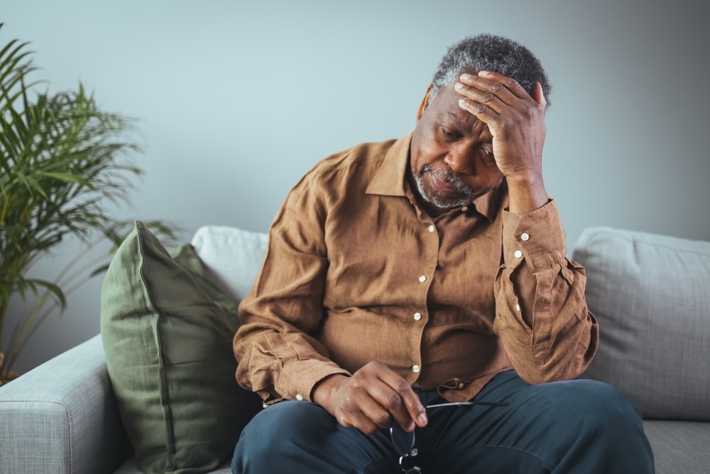 Elderly man in a brown shirt having a tough time in recovering from addiction