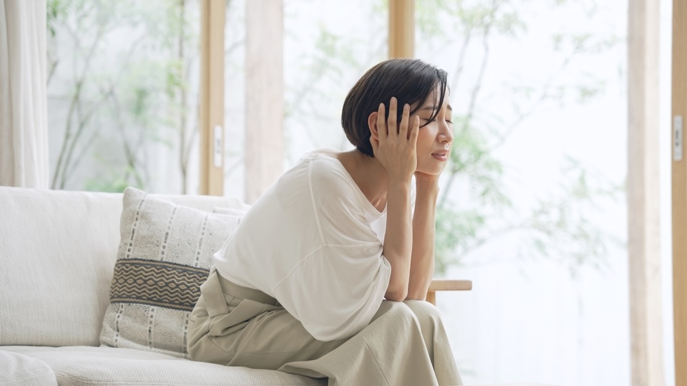 Female on the couch having a challenging time while in addiction treatment