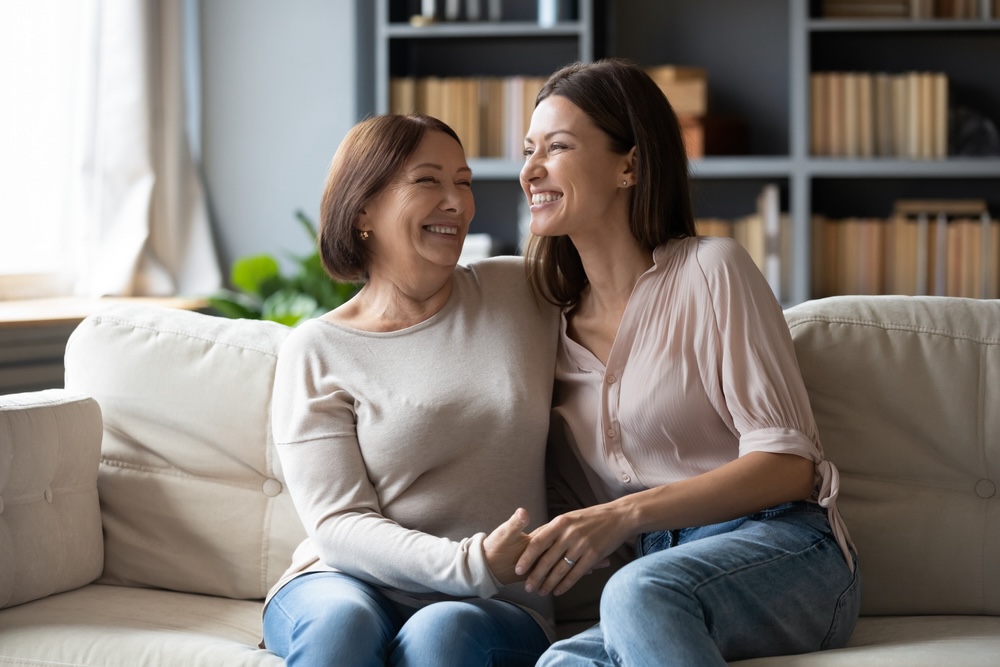 Mother and daughter sitting on the couch celebrating sobriety from alcohol