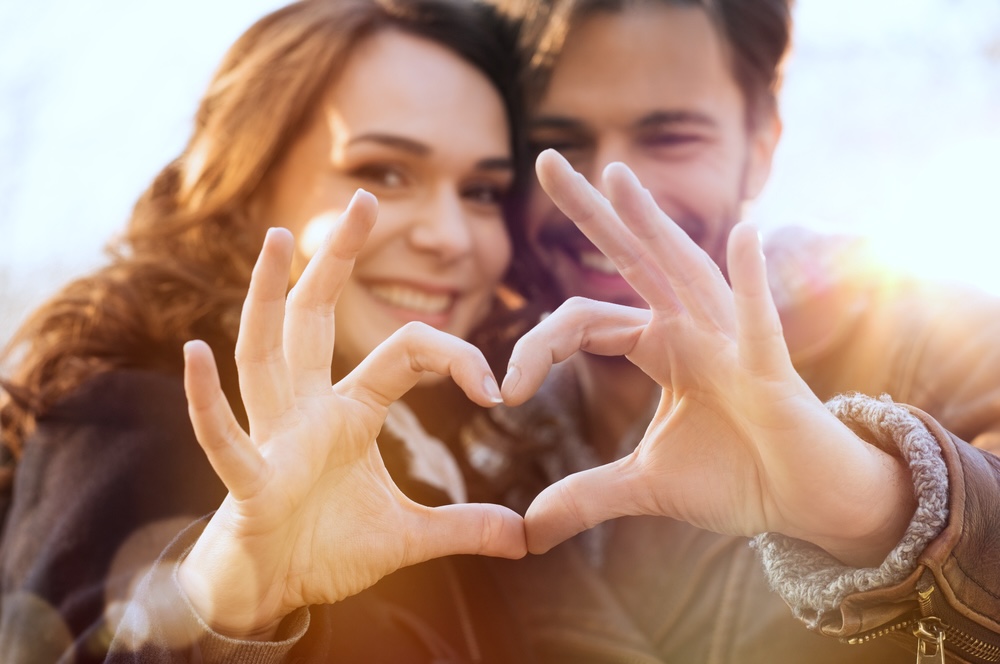 Sober couple doing the heart hand sign