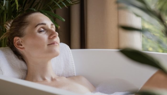 Woman relaxing in a bathtub