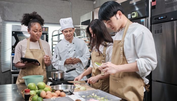 A group of sober people doing cooking activities with a chef