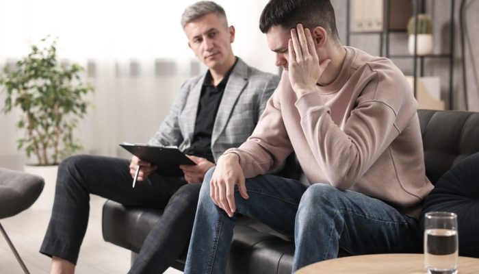 A psychotherapist working with patient suffering from addiction