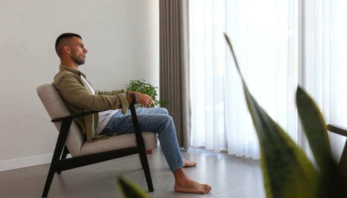 A man alone in a room at luxury drug rehab